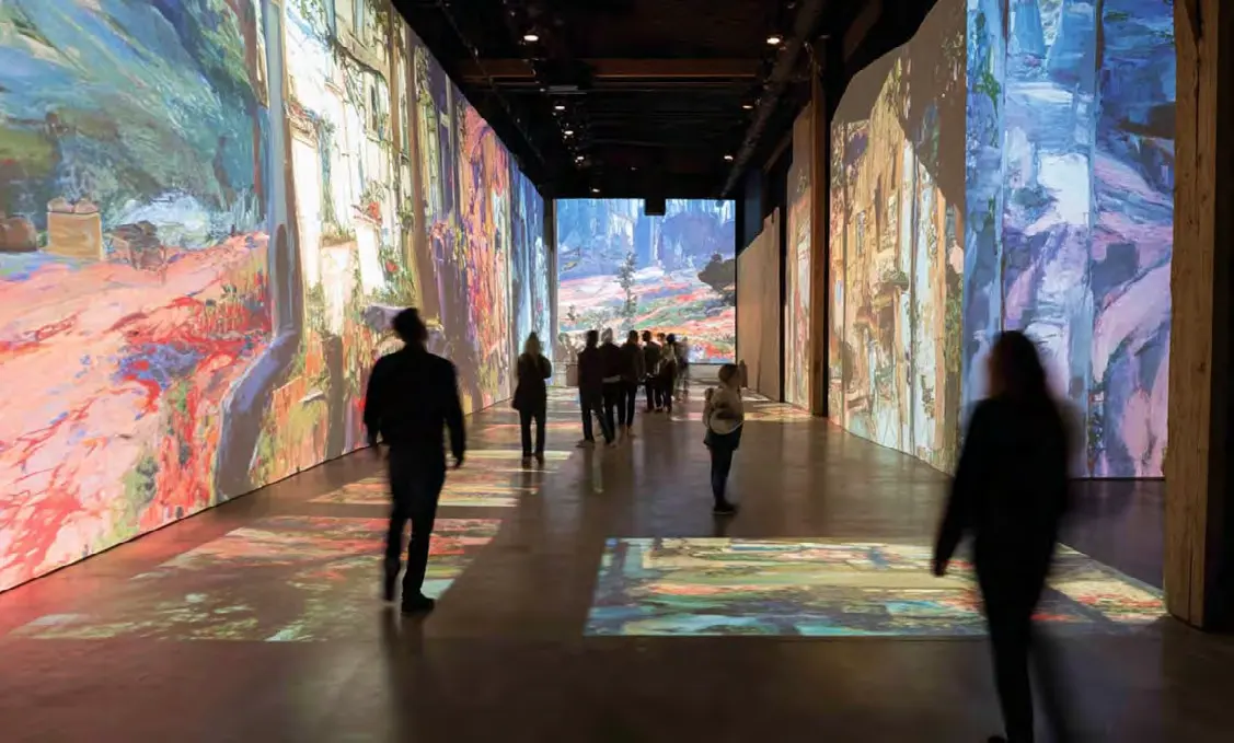 Visitors inside an immersive projection exhibition